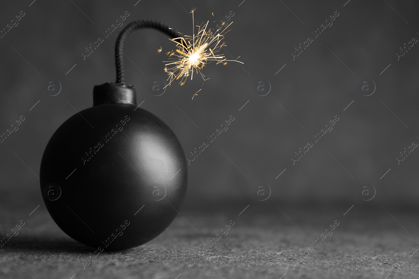 Photo of Old fashioned fuse bomb on grey table. Space for text