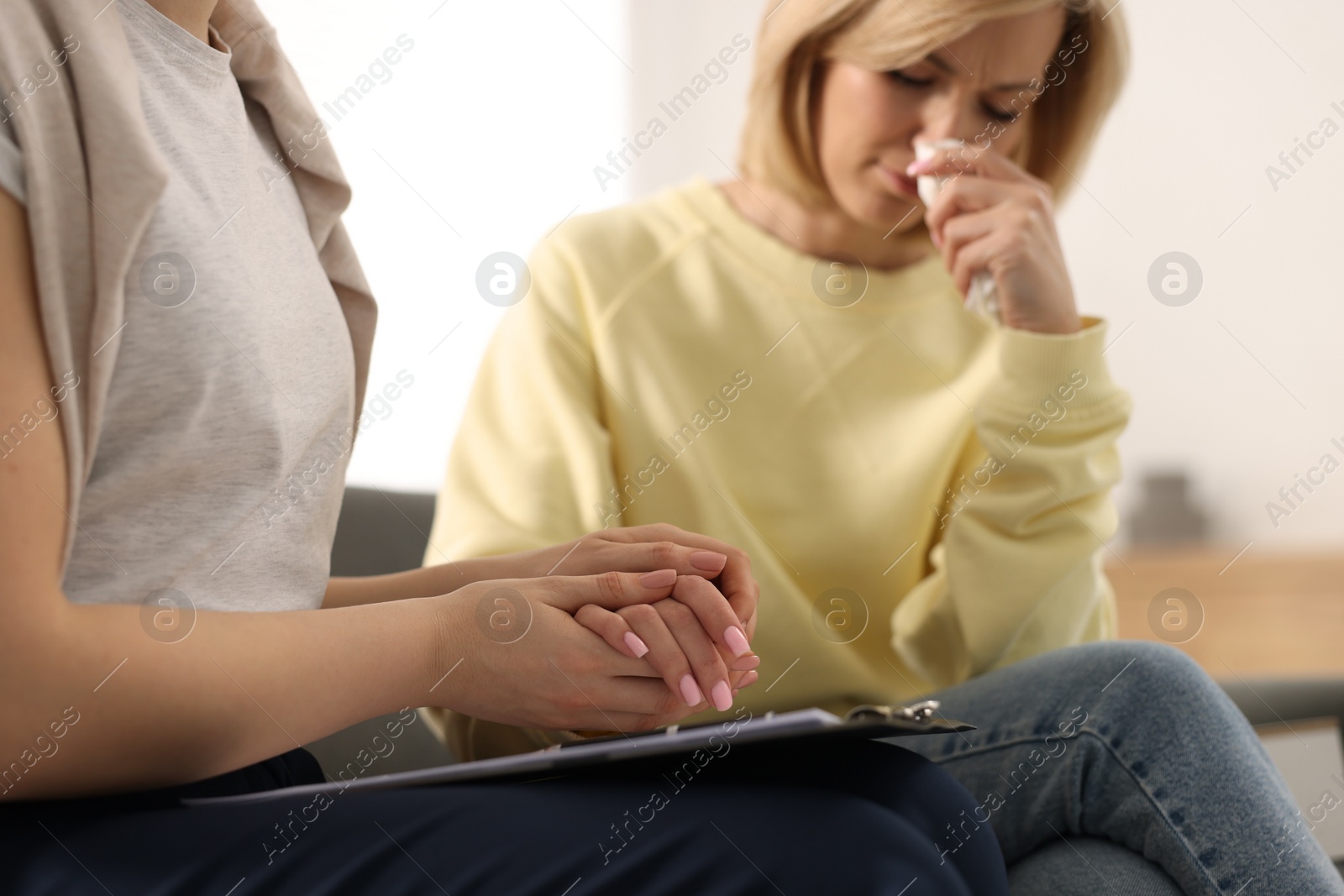 Photo of Professional psychotherapist working with patient in office, closeup