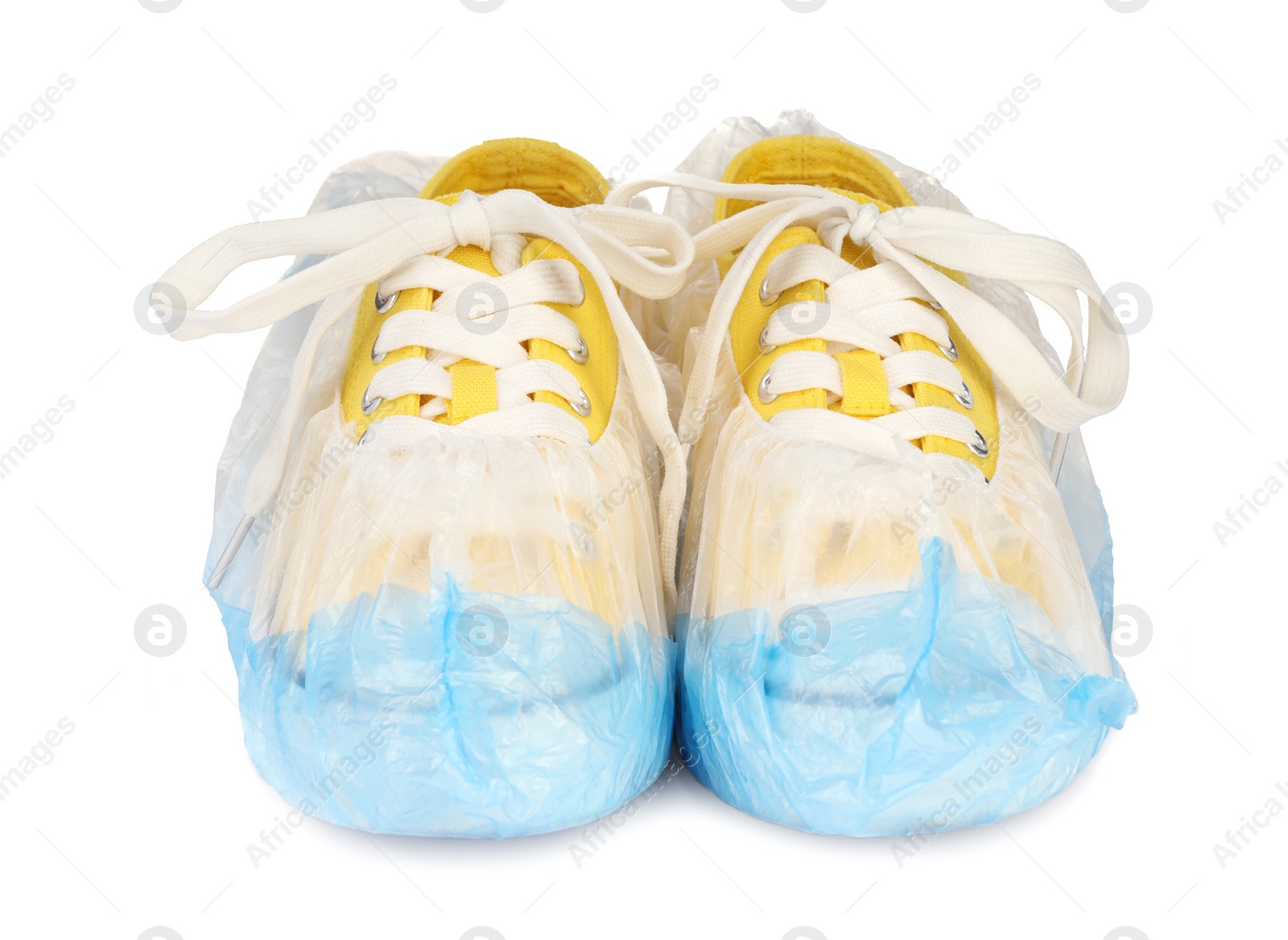 Photo of Sneakers in blue shoe covers isolated on white