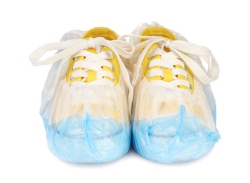 Sneakers in blue shoe covers isolated on white