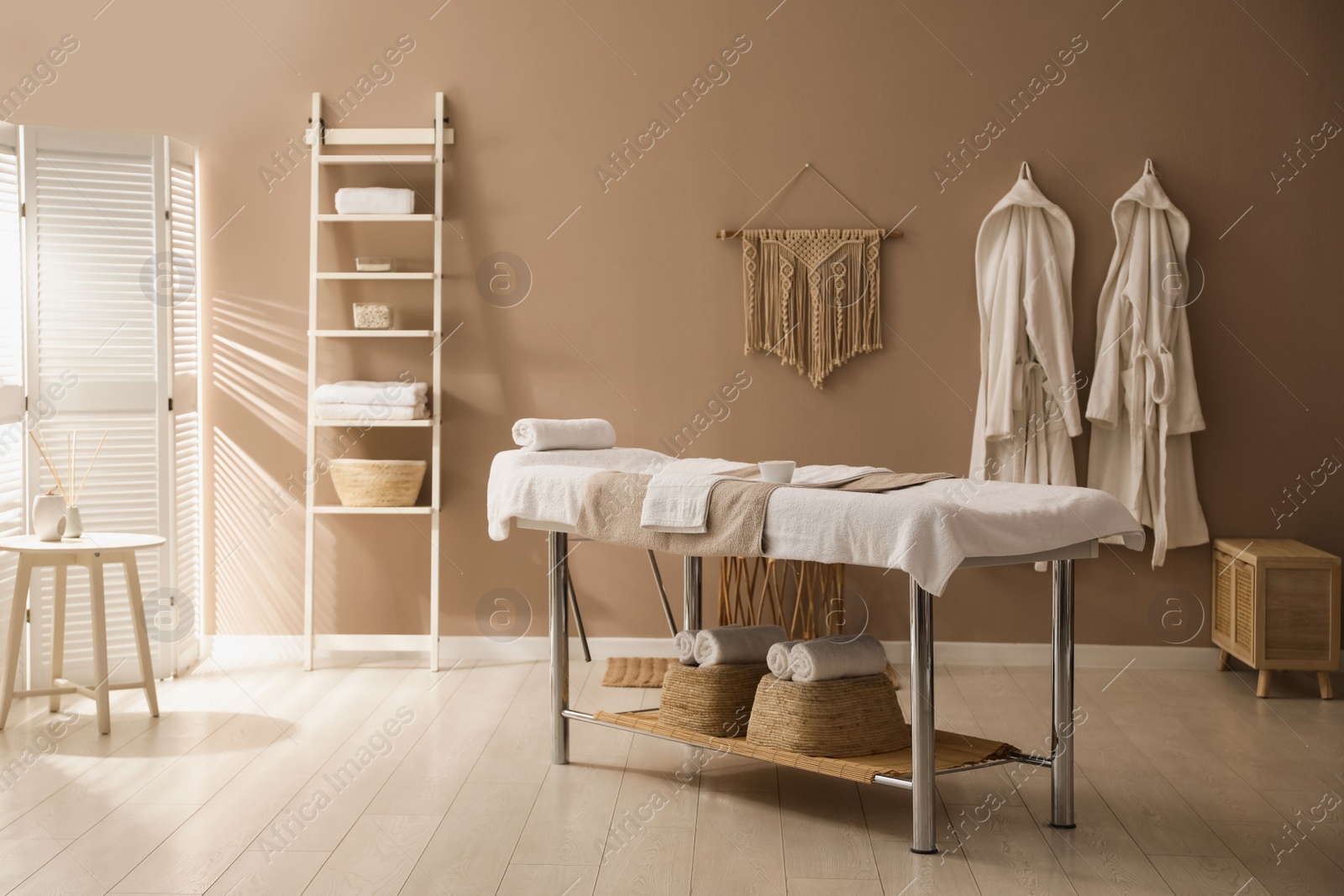 Photo of Stylish spa salon interior with massage table