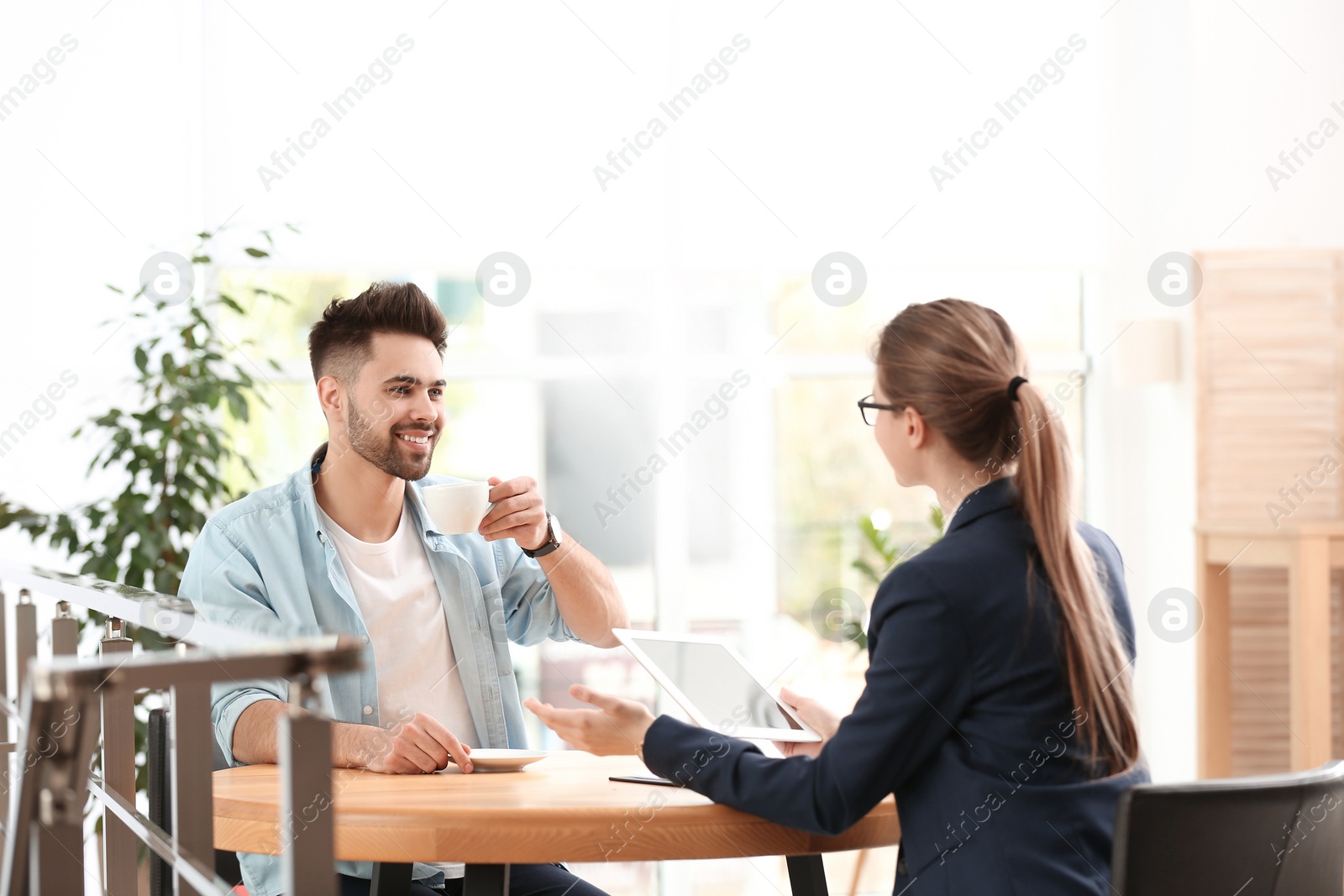 Photo of Female insurance agent working with client in office