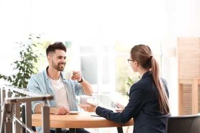 Female insurance agent working with client in office