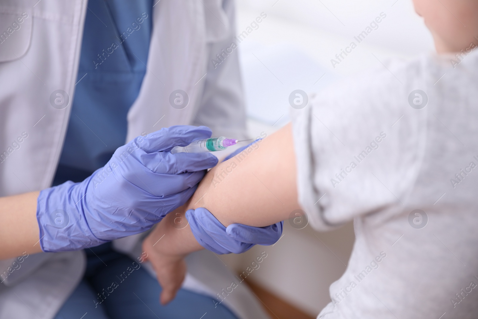 Photo of Little girl receiving chickenpox vaccination in clinic, closeup. Varicella virus prevention