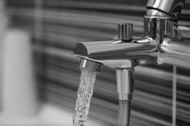 Image of Water flowing from tap in bathroom, closeup