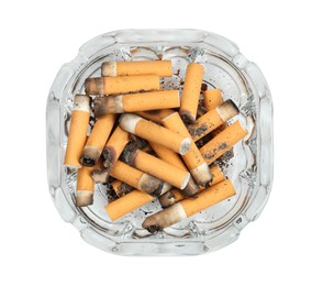 Photo of Glass ashtray full of cigarette stubs isolated on white, top view