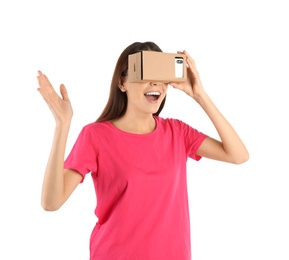 Photo of Young woman using cardboard virtual reality headset, isolated on white