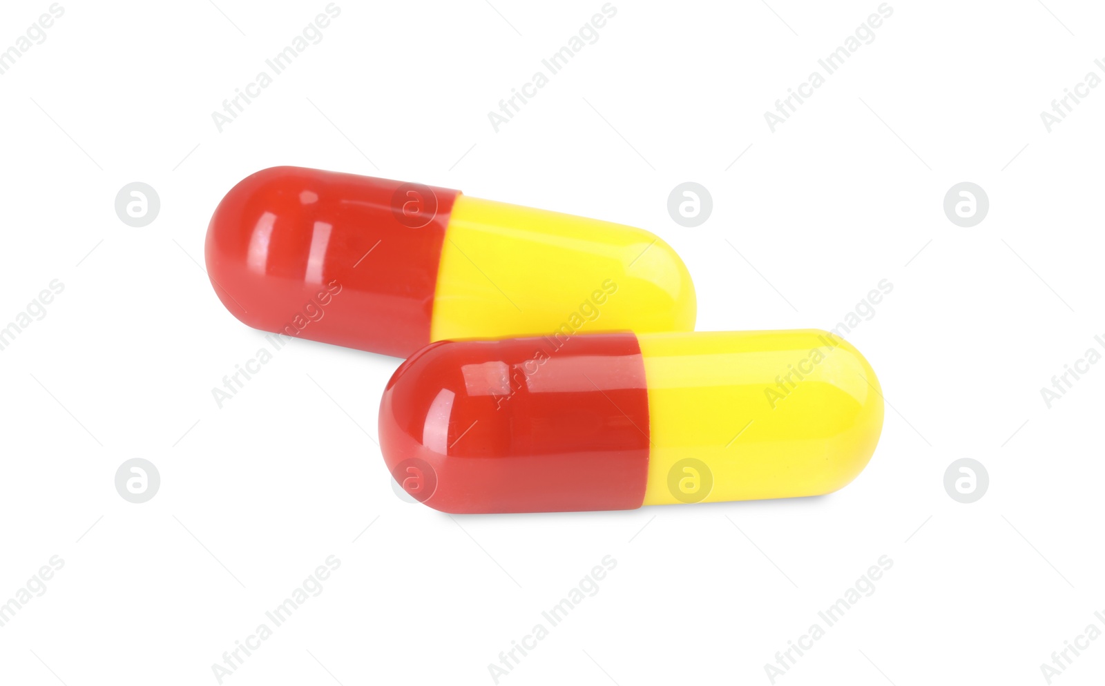 Photo of Two antibiotic pills isolated on white. Medicinal treatment