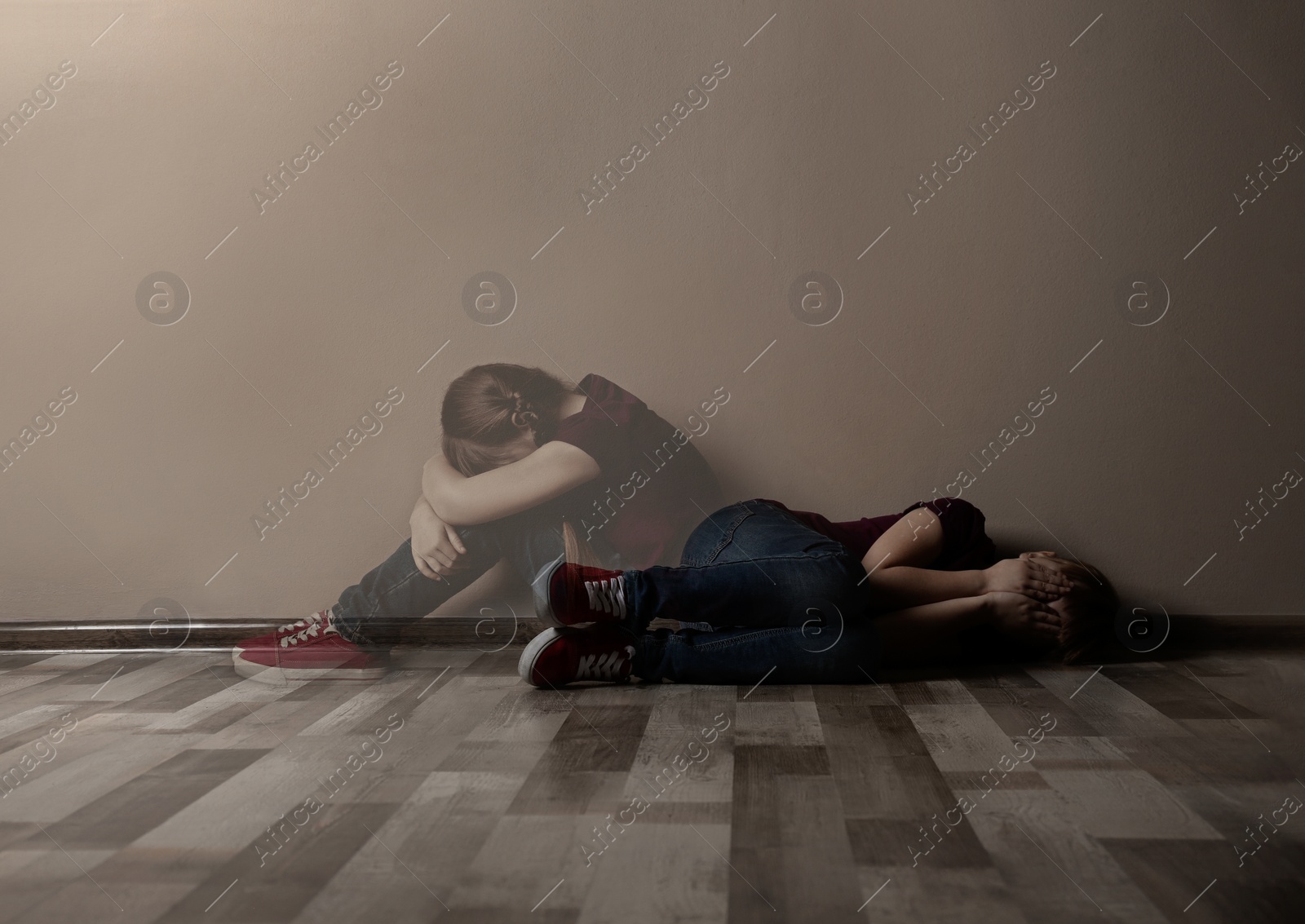 Image of Upset little girl alone near beige wall. Autophobia - fear of isolation