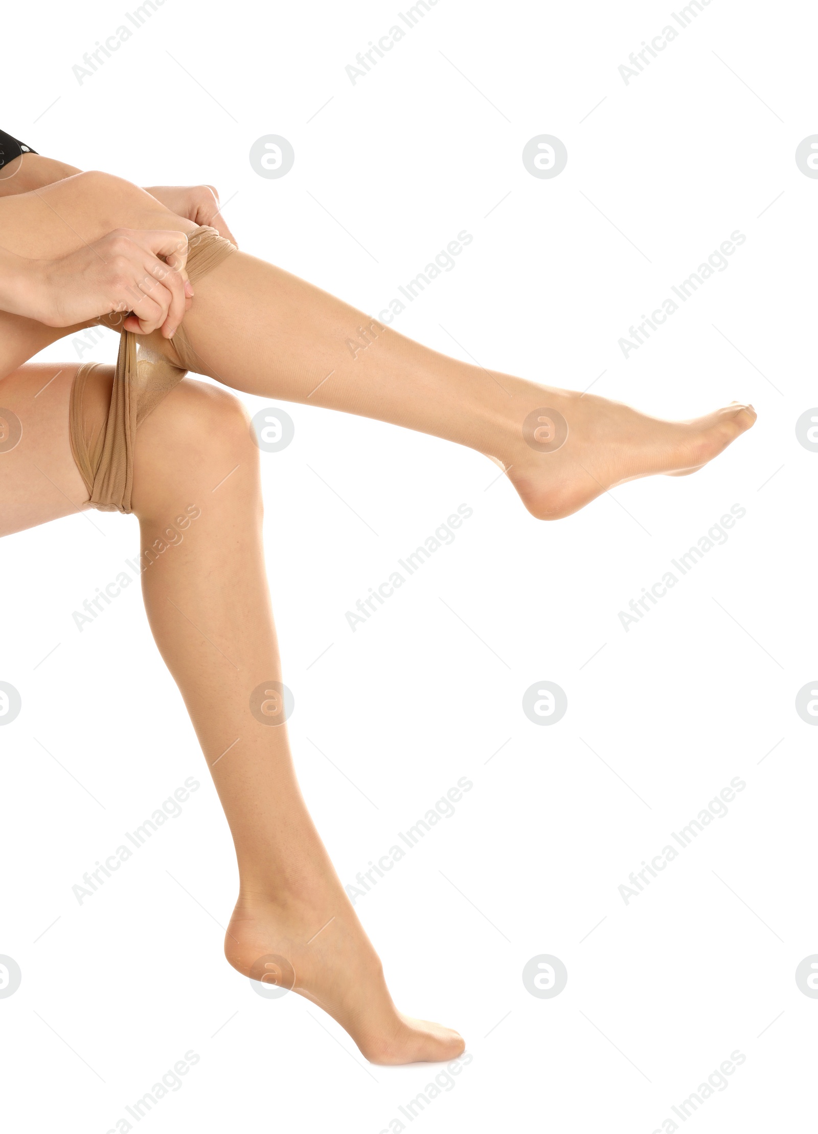 Photo of Woman putting on tights on white background, closeup