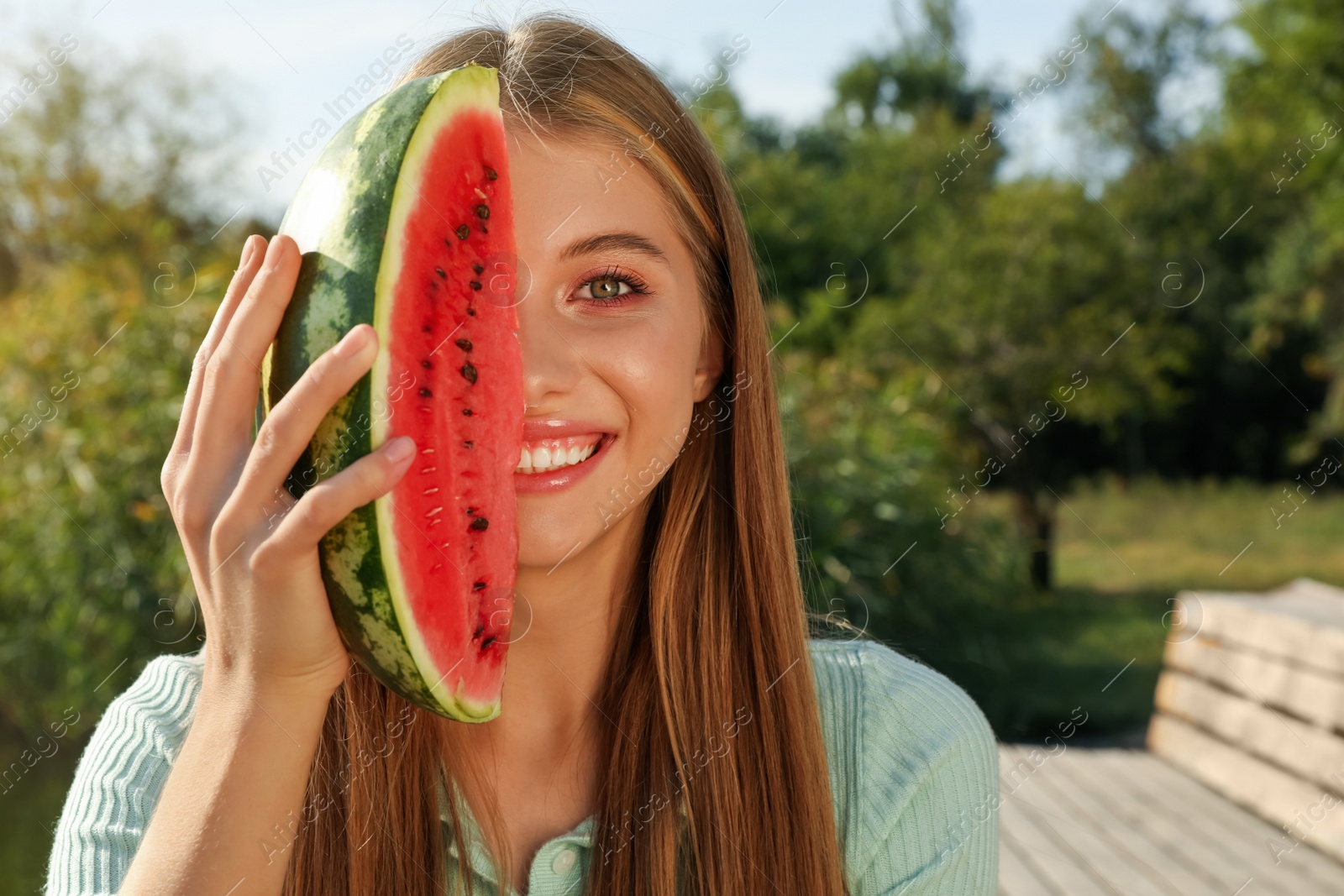 Photo of Beautiful girl with slice of watermelon outdoors