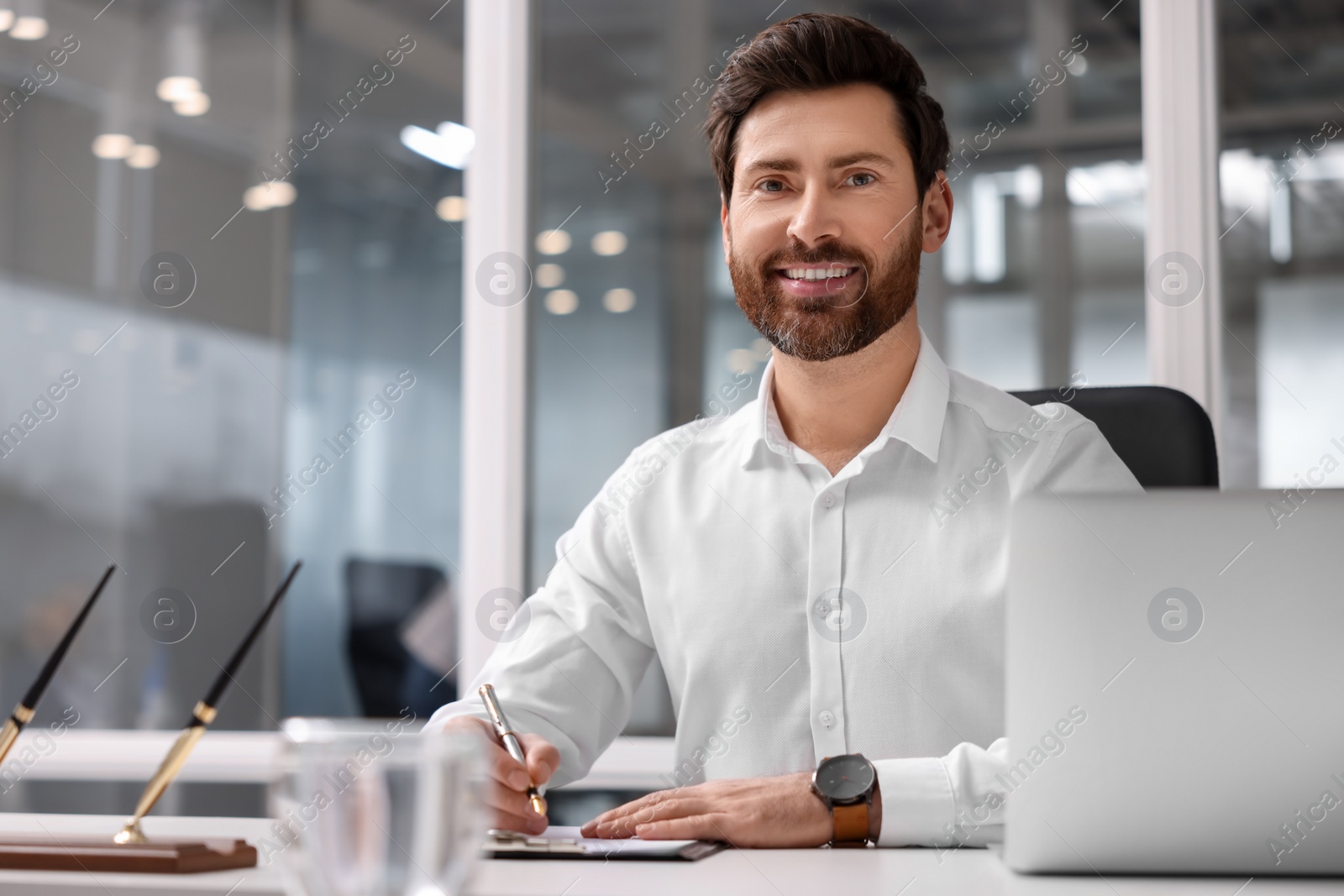 Photo of Portrait of smiling man working in office, space for text. Lawyer, businessman, accountant or manager