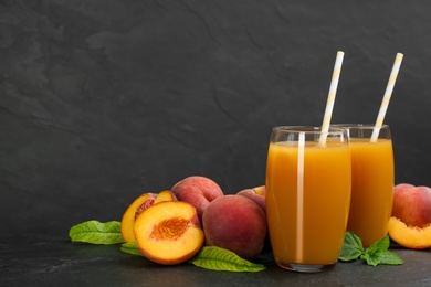 Natural freshly made peach juice on grey table. Space for text