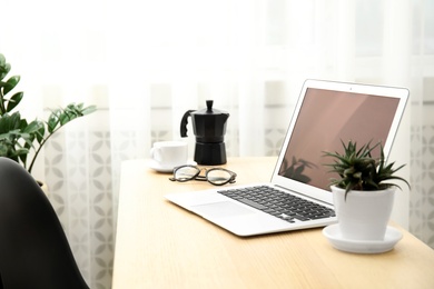 Photo of Cozy blogger workplace with laptop at home