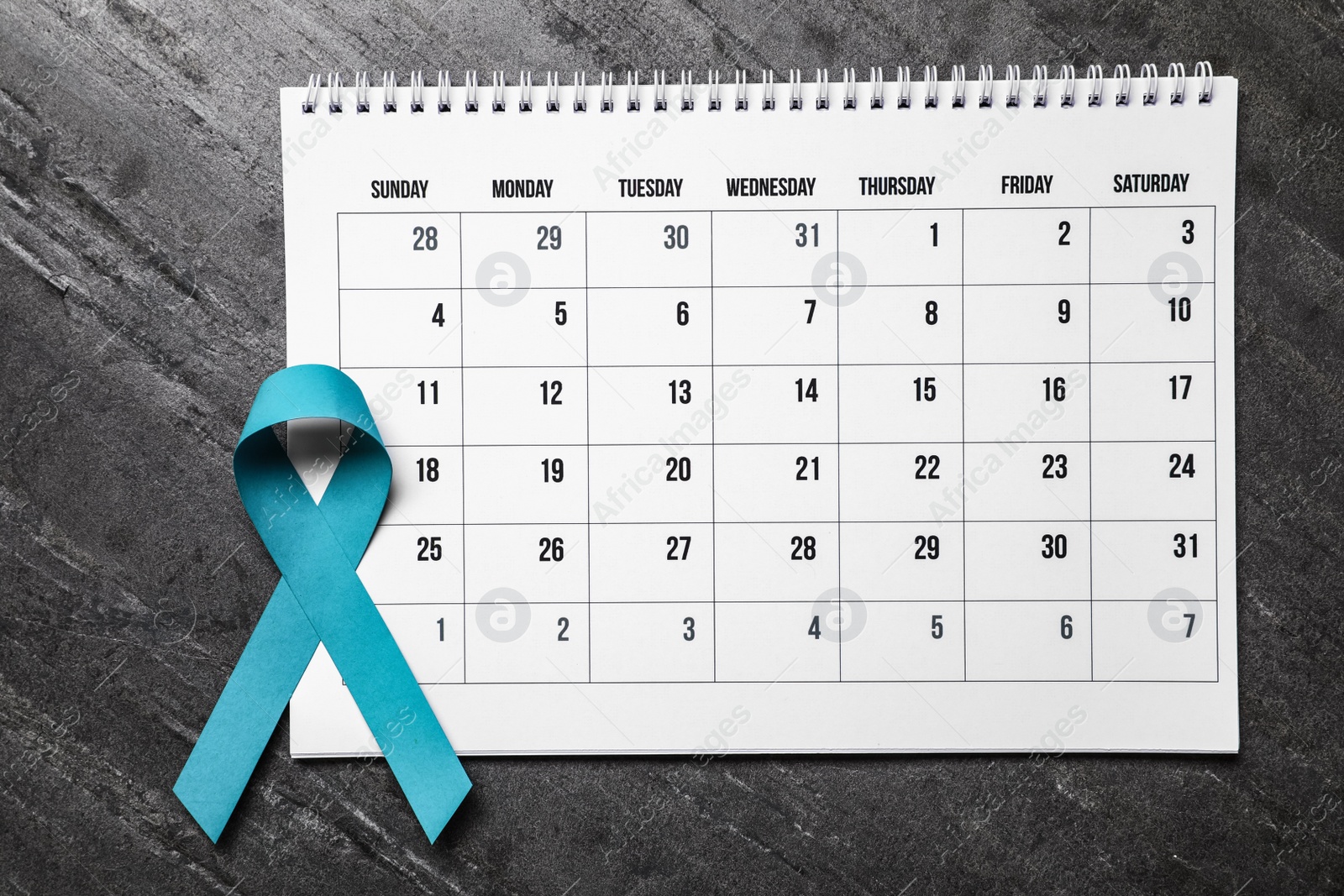 Photo of Flat lay composition with teal ribbon and calendar on grey background