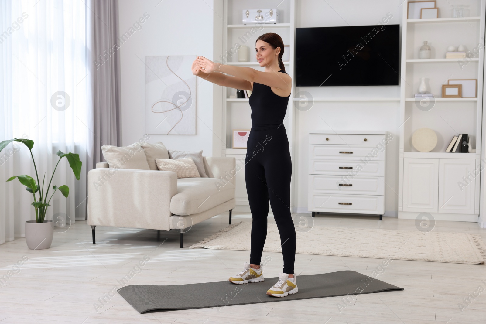 Photo of Happy woman doing morning exercise at home