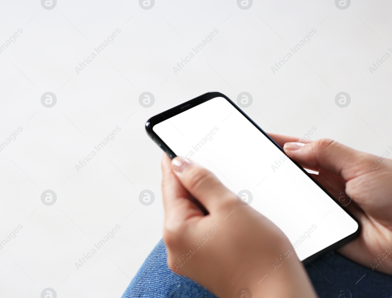 Photo of Closeup view of woman with smartphone indoors. Space for text