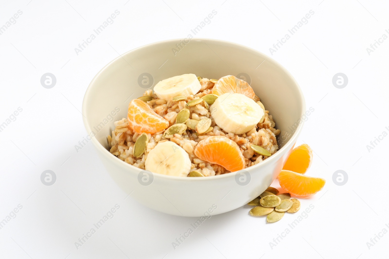 Photo of Tasty oatmeal with fruits and pumpkin seeds on white background. Healthy breakfast