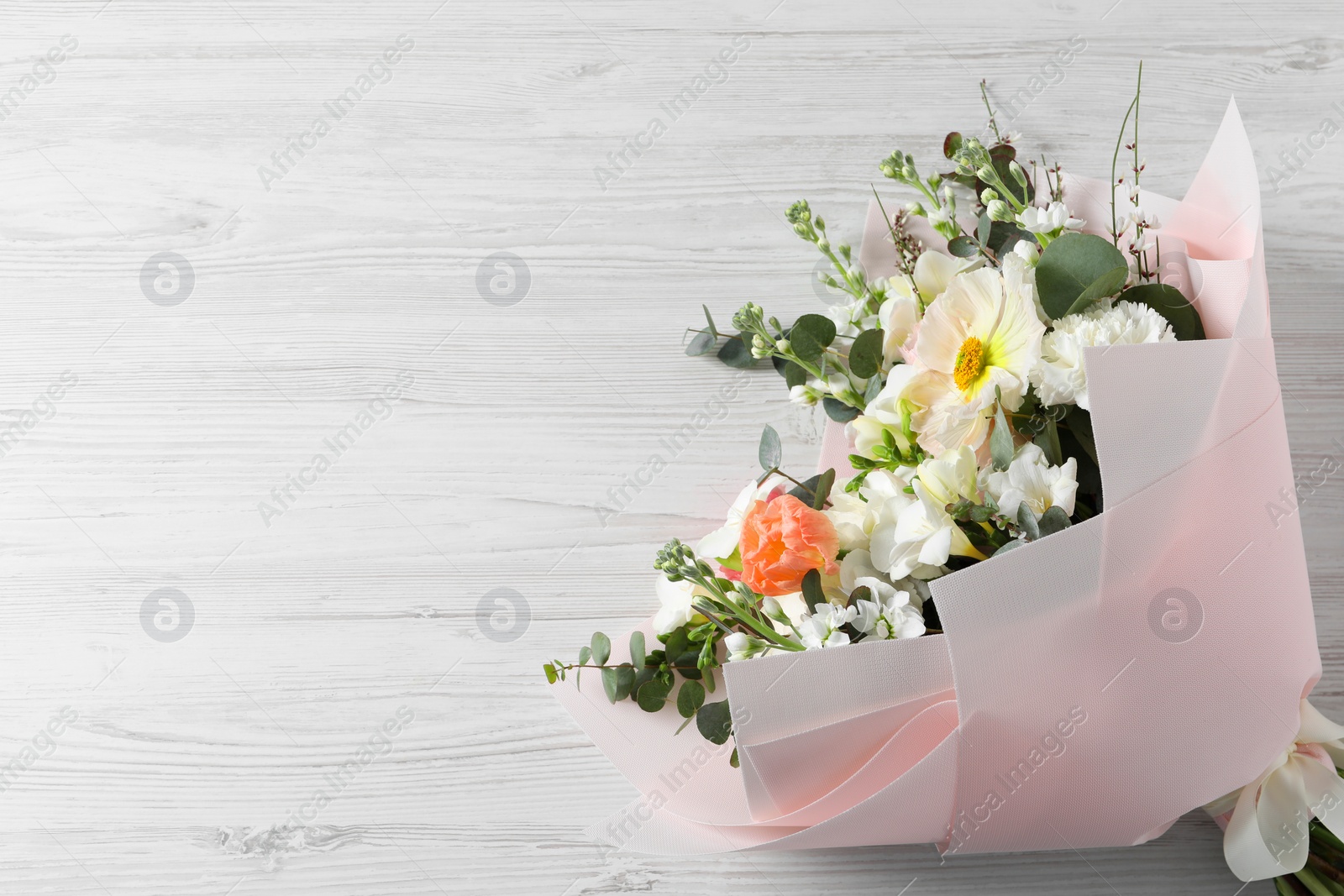 Photo of Bouquet of beautiful flowers on white wooden table, top view. Space for text