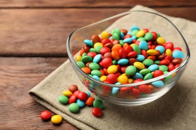 Photo of Tasty colorful candies on wooden table, closeup