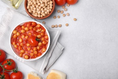 Delicious chickpea curry on light gray table, flat lay. Space for text