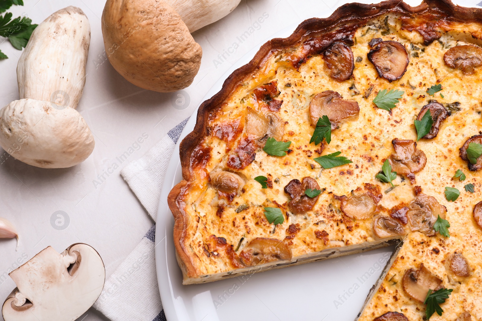 Photo of Delicious pie with mushrooms and cheese served on light table, flat lay