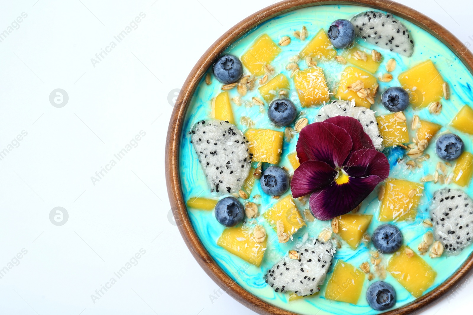 Photo of Delicious smoothie bowl with fresh fruits, blueberries, flower and oatmeal on white background, top view. Space for text