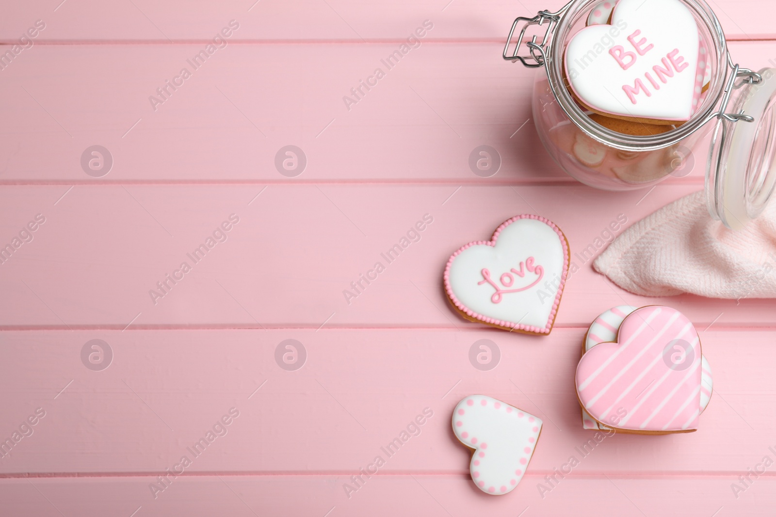 Photo of Valentine's day cookies on pink table, flat lay. Space for text