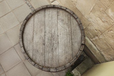 Photo of Traditional wooden barrel outdoors, top view. Wine making