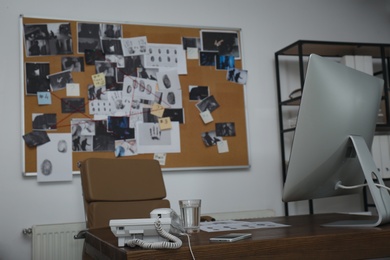 Photo of Modern detective office with computer and board