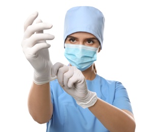 Doctor in protective mask and scrubs putting on medical gloves against white background