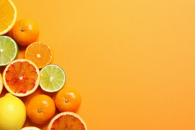 Different citrus fruits on color background, flat lay. Space for text