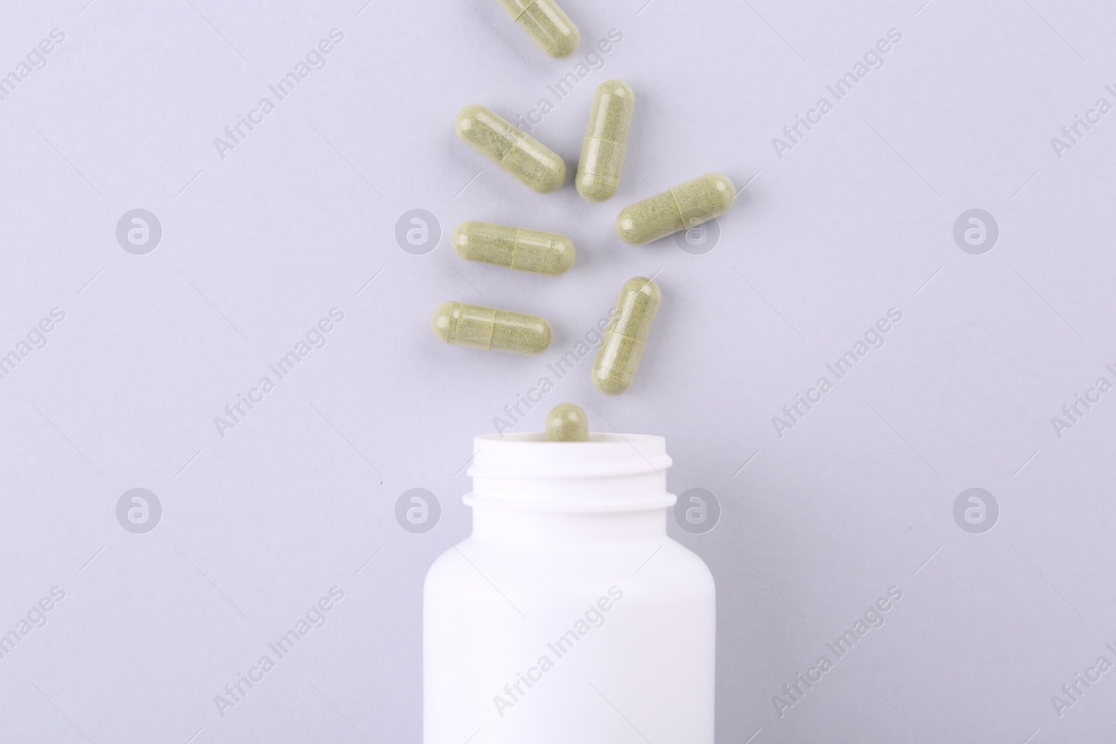 Photo of Jar with vitamin capsules on white background, top view