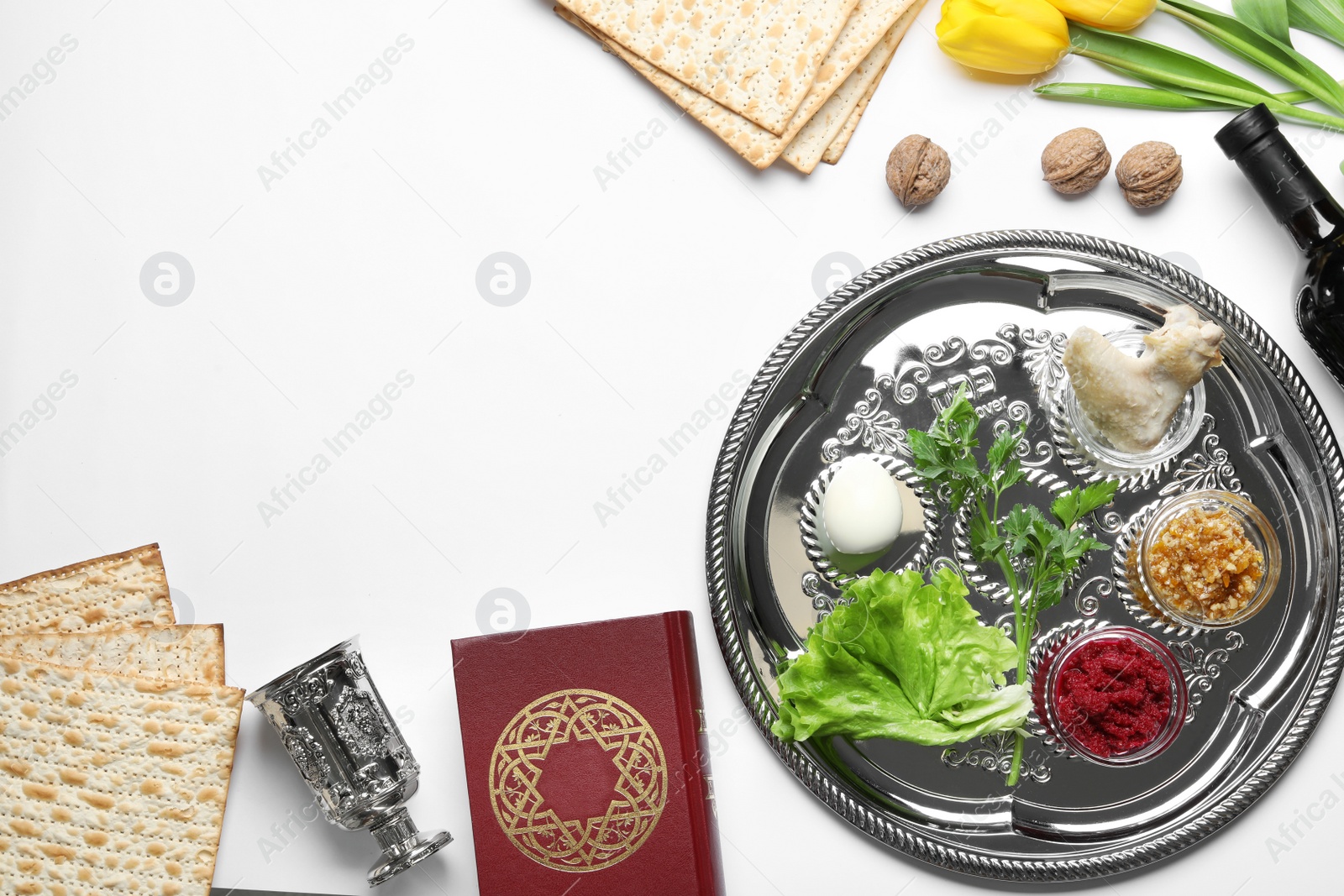 Photo of Flat lay composition with symbolic Passover (Pesach) items and meal on white background