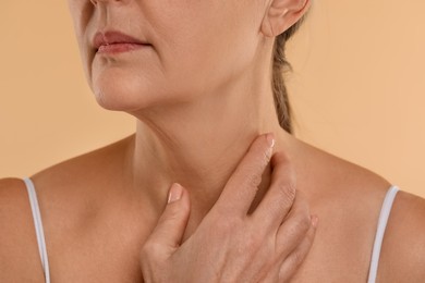 Woman with normal skin on beige background, macro view