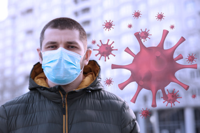 Man wearing medical mask outdoors during coronavirus outbreak