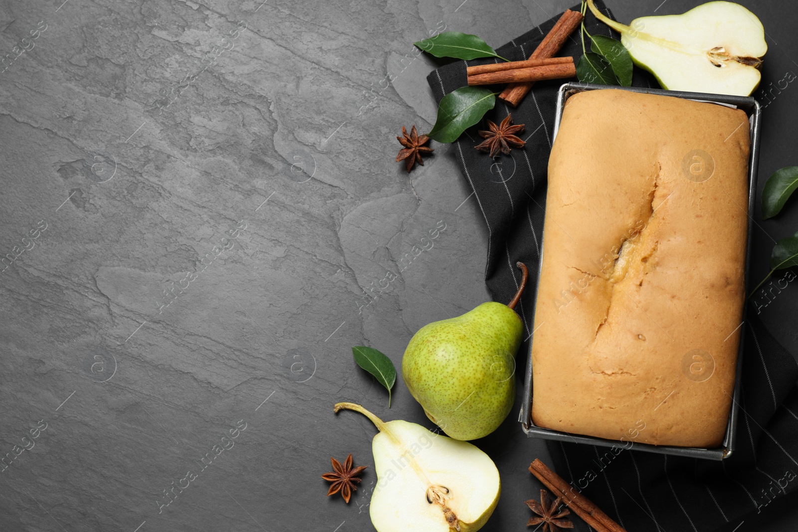 Photo of Flat lay composition with pear bread on black slate table, space for text. Homemade cake