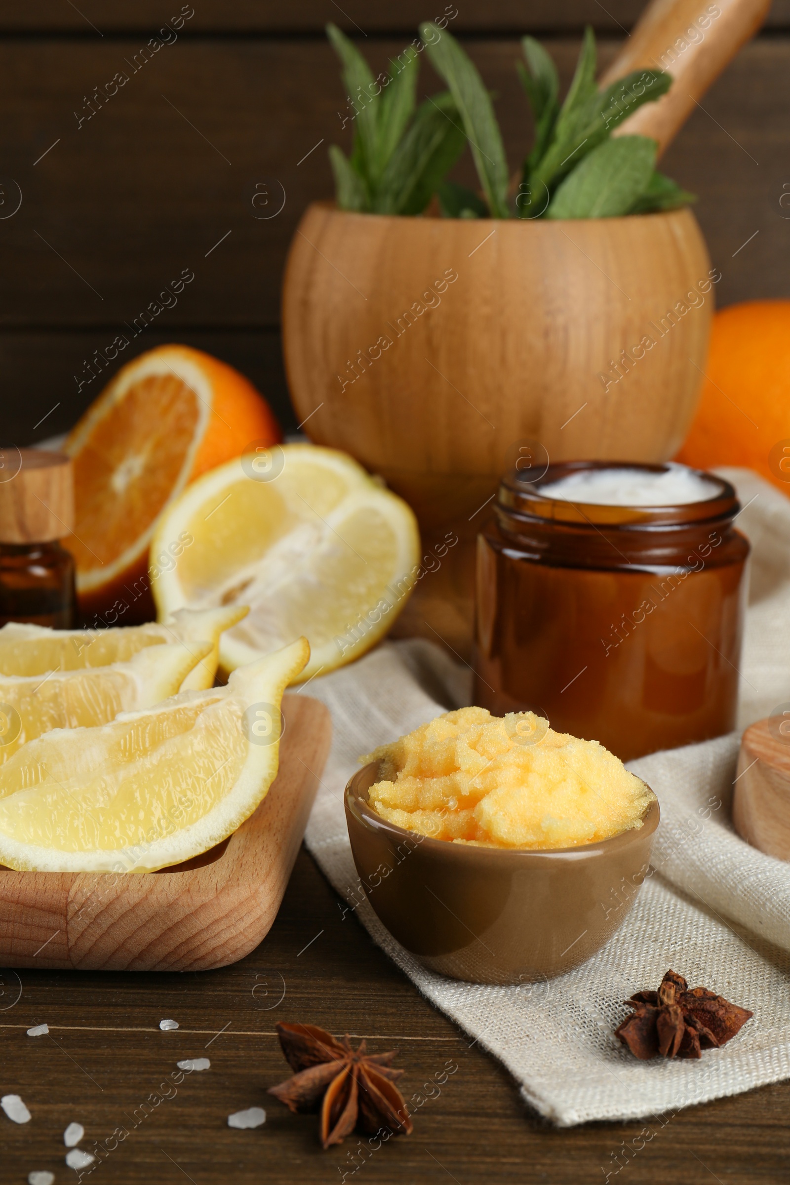 Photo of Homemade cosmetic products and fresh ingredients on wooden table