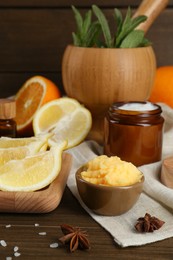 Photo of Homemade cosmetic products and fresh ingredients on wooden table