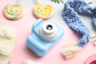 Photo of Light blue toy camera on color background. Future photographer