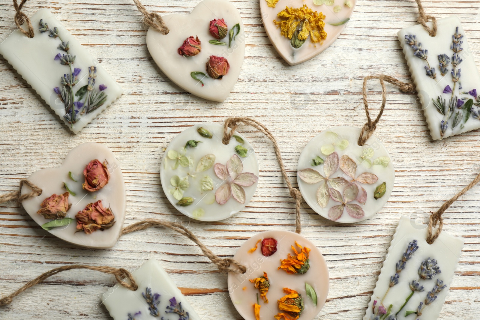 Photo of Beautiful scented sachets on white wooden table