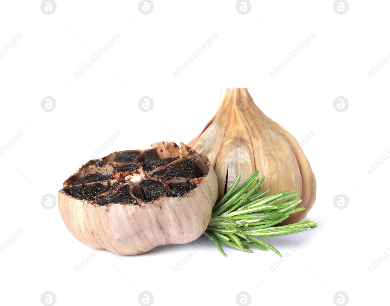 Photo of Aged black garlic with rosemary on white background