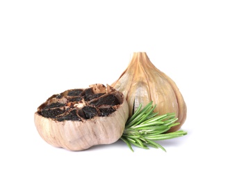 Aged black garlic with rosemary on white background