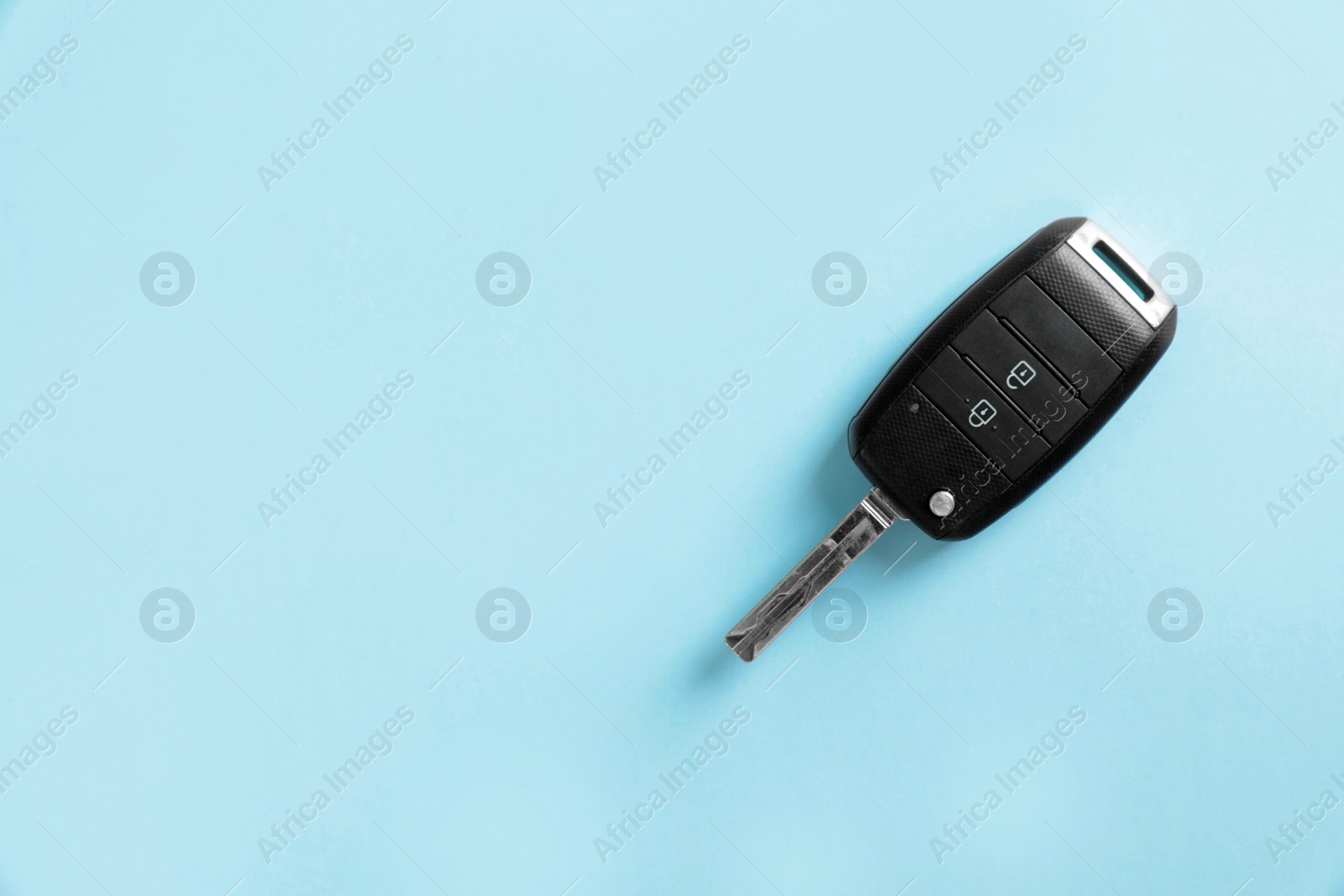 Photo of Car key on color background, top view with space for text