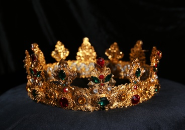 Beautiful golden crown on black velvet pillow. Fantasy item