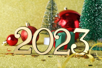 Photo of Number 2023 and festive decor on bright background. Happy New Year