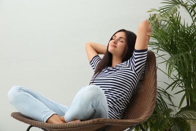 Photo of Young woman relaxing on chair at home