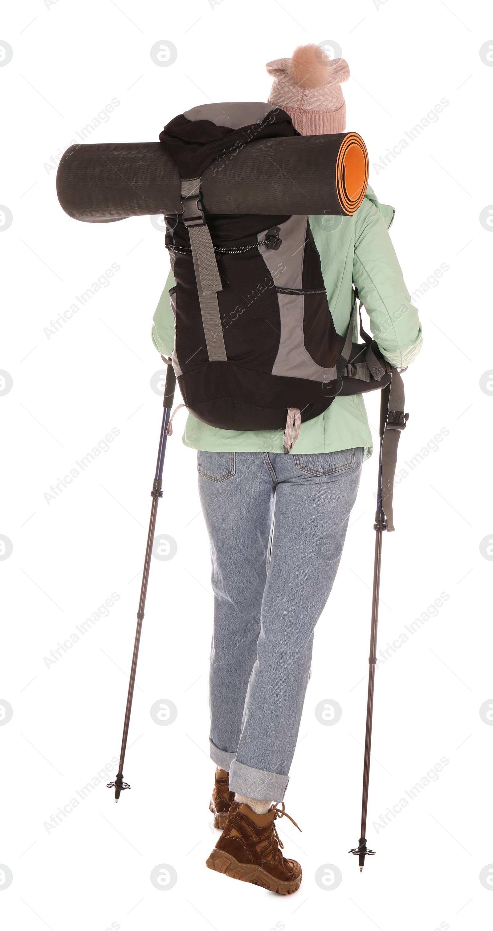 Photo of Female hiker with backpack and trekking poles on white background, back view