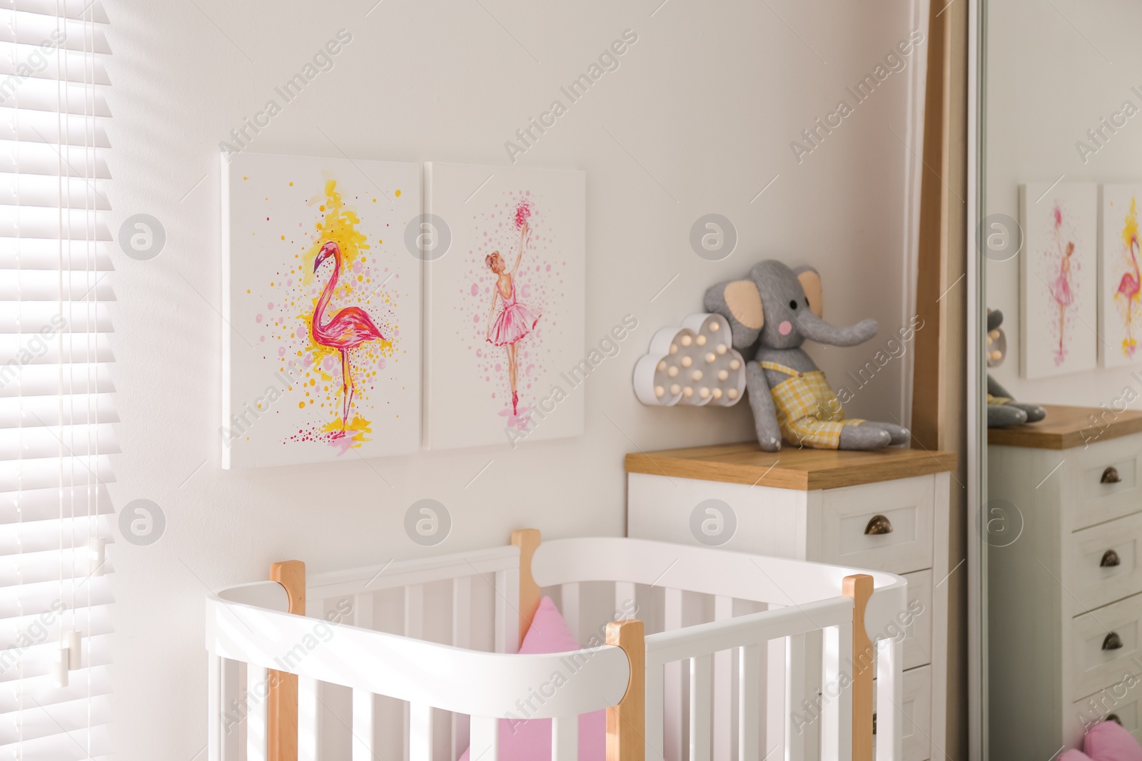 Photo of Baby room interior with beautiful pictures on wall