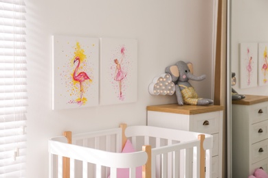 Baby room interior with beautiful pictures on wall